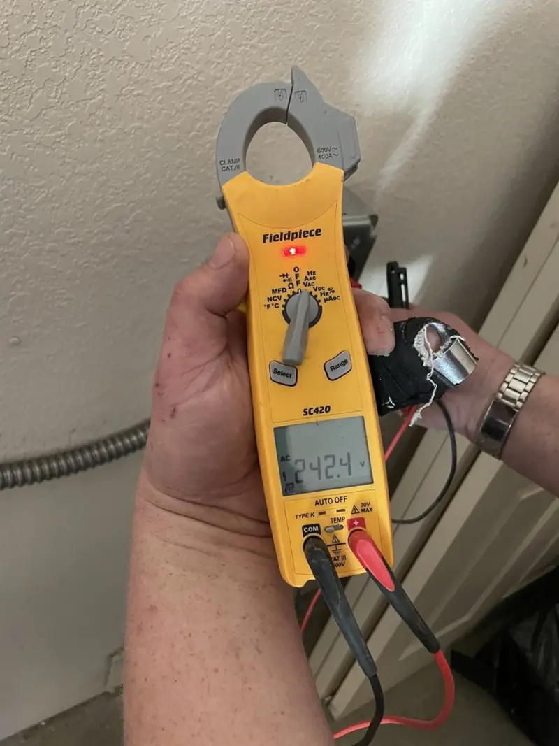 Voltage testing with clamp meter during Ceiling Fan Installation in Sterling Heights